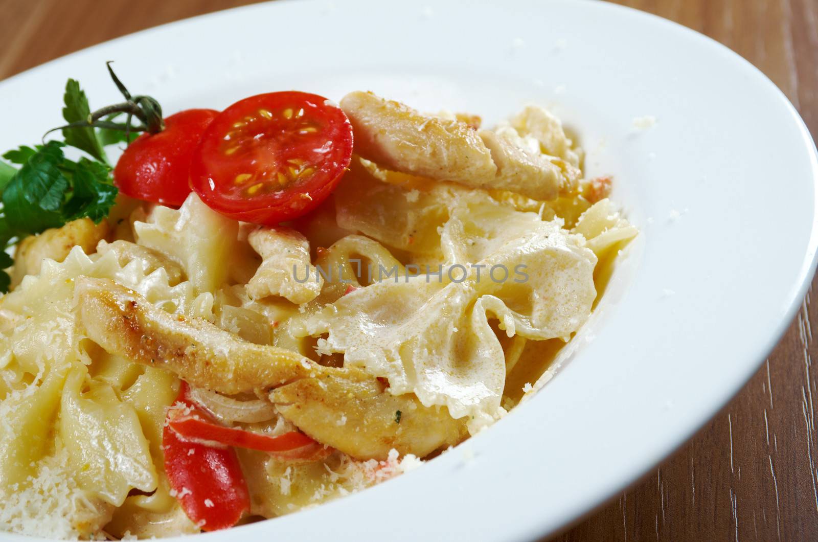 Farfalle pasta with cream sauce and tomatoes
