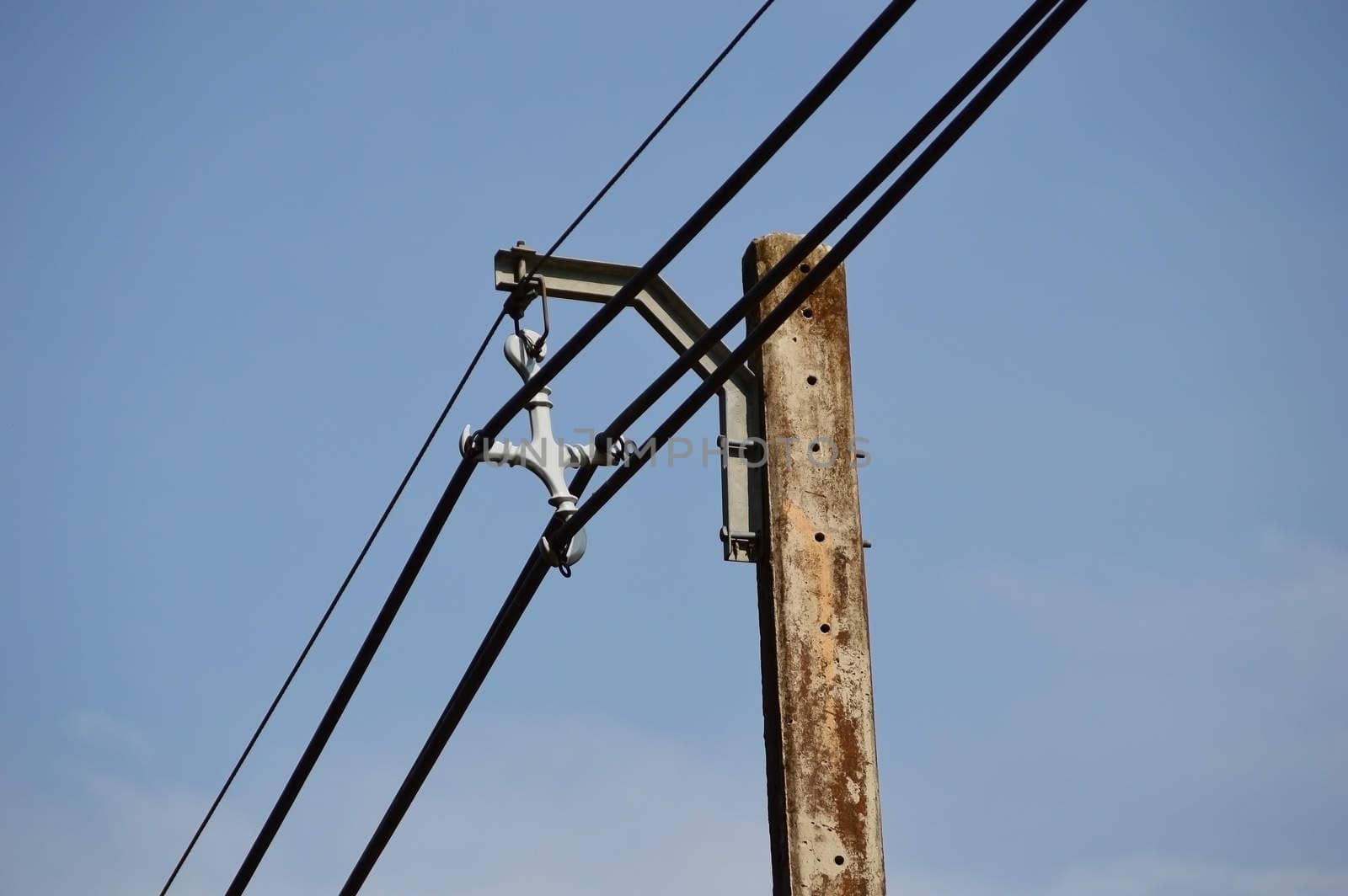 Photo of an electric pole with a many cables by Lekchangply