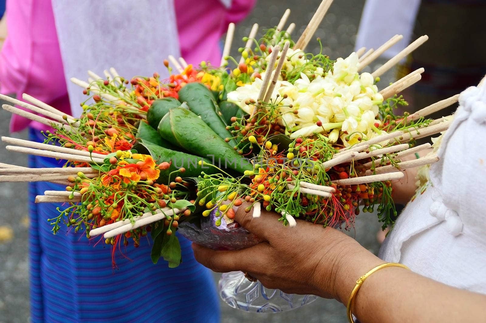 flowers in tray on women hand for buddhist sacrifice by Lekchangply