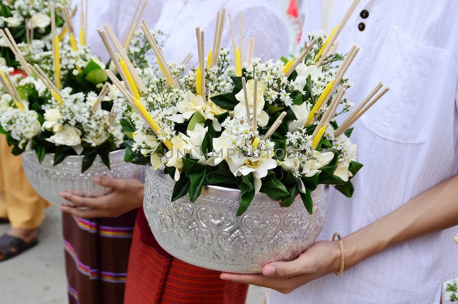 flowers in tray on women hand for buddhist sacrifice, from Intakin Festival, Chiangmai Thailand