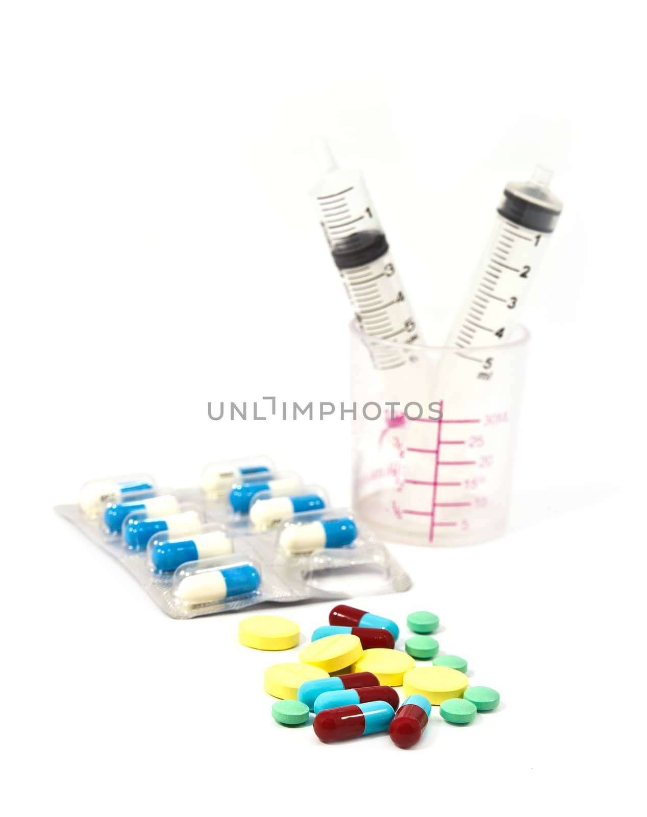 Medicine pills and tablet with syringe in the bottles
