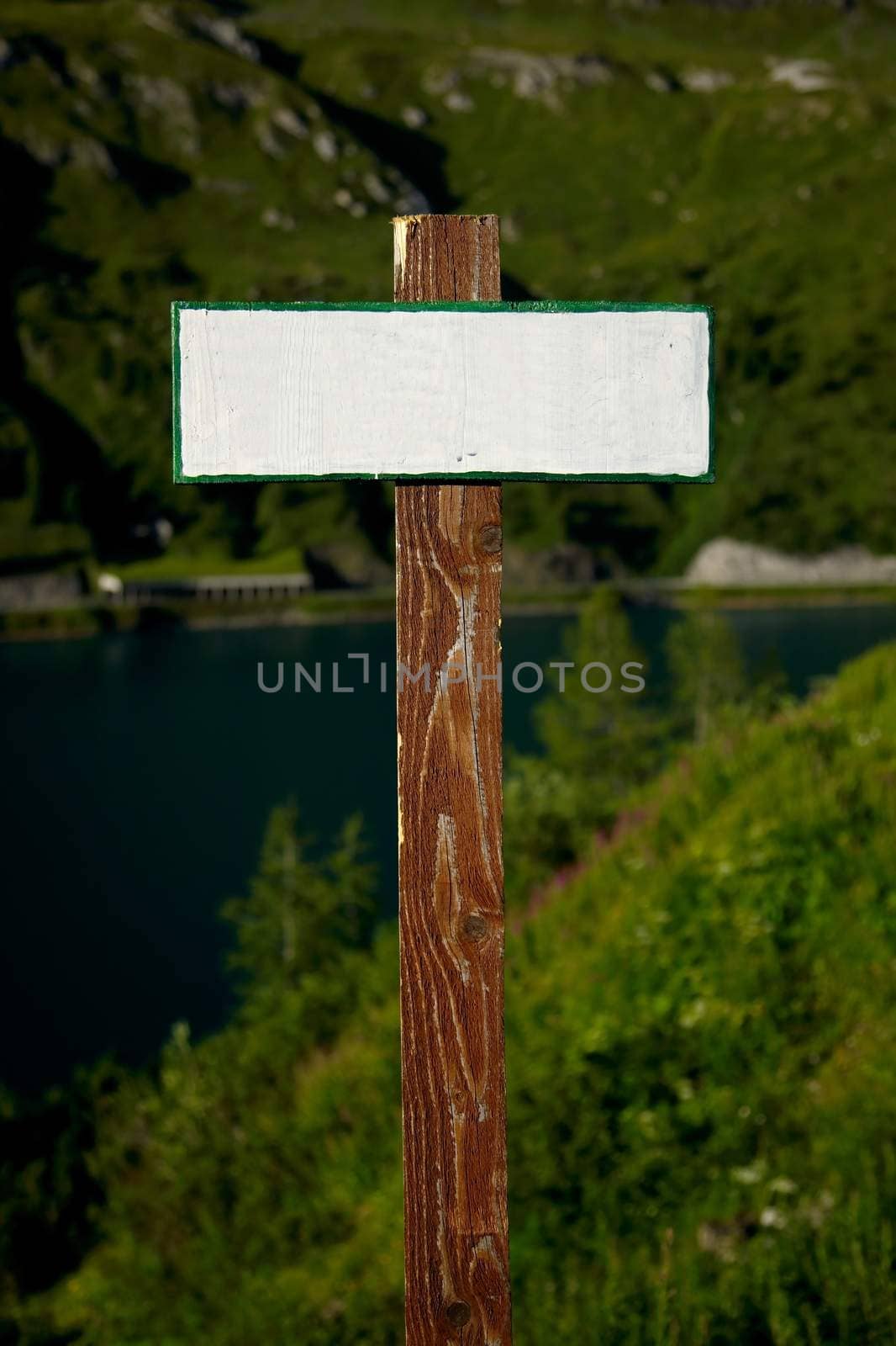 Blank, empty signpost in a mountain landscape
