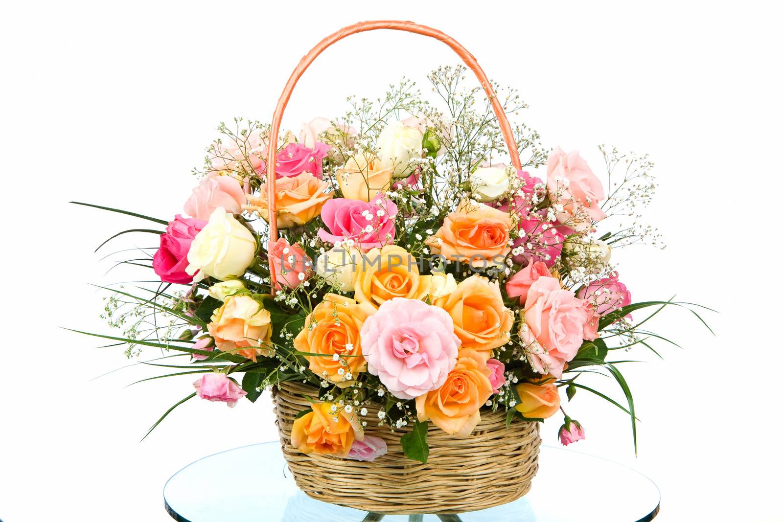 Basket with colored roses on white background