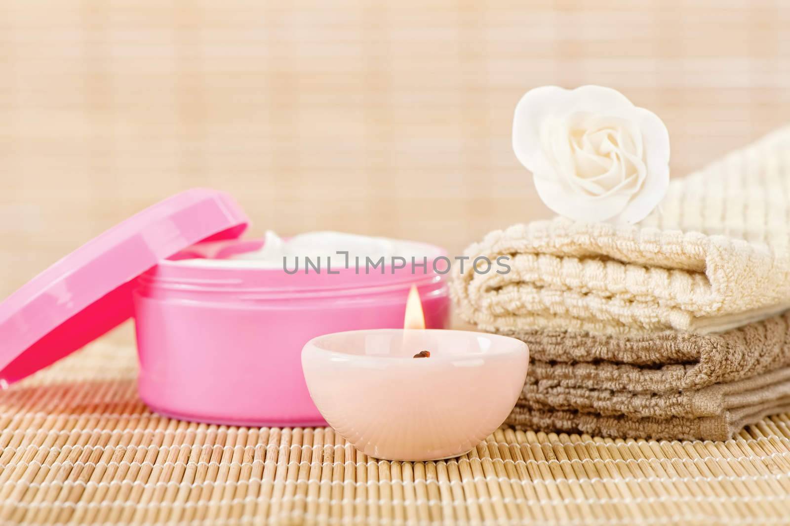 Skin care set with romantic candle in front