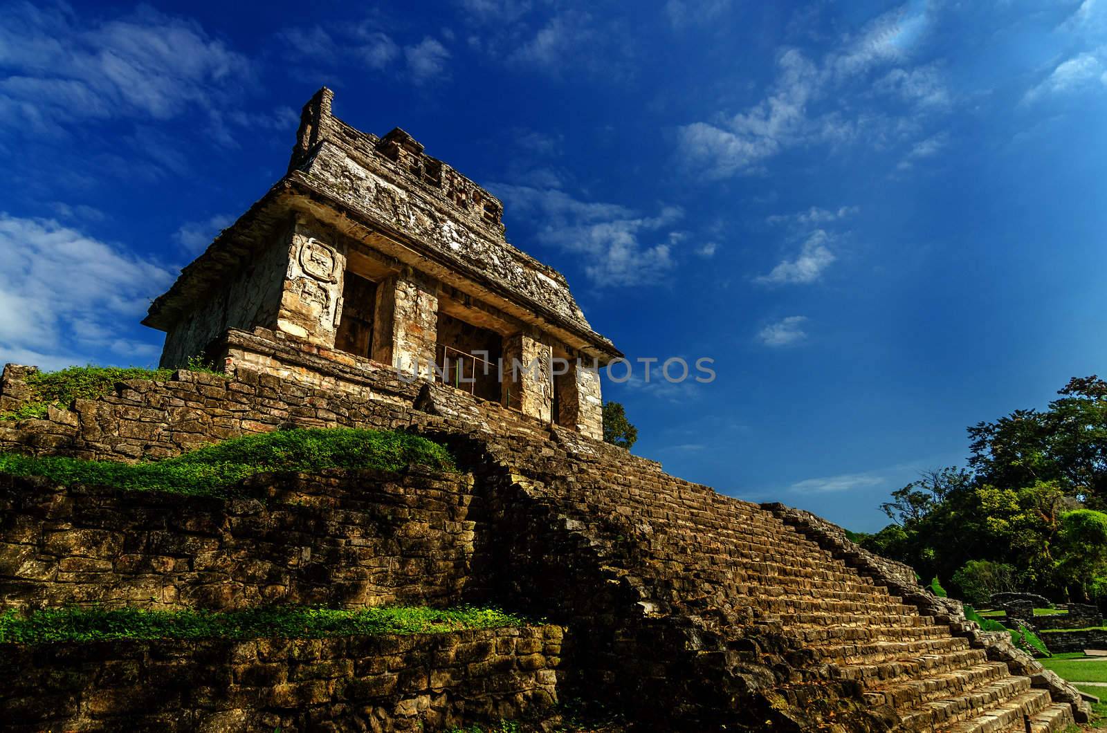 Temple in ancient Mayan city of Palenque with a beautiful blue sky