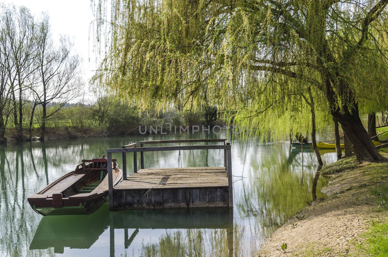 Old lonely boat attached to floating dock.