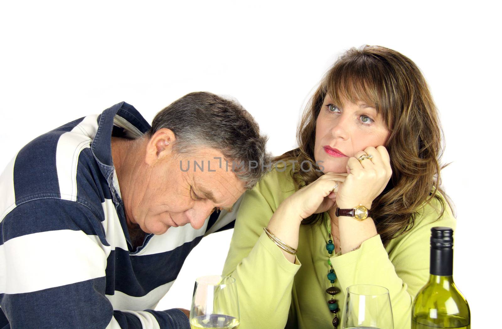 Dejected middle aged couple after having had an argument.