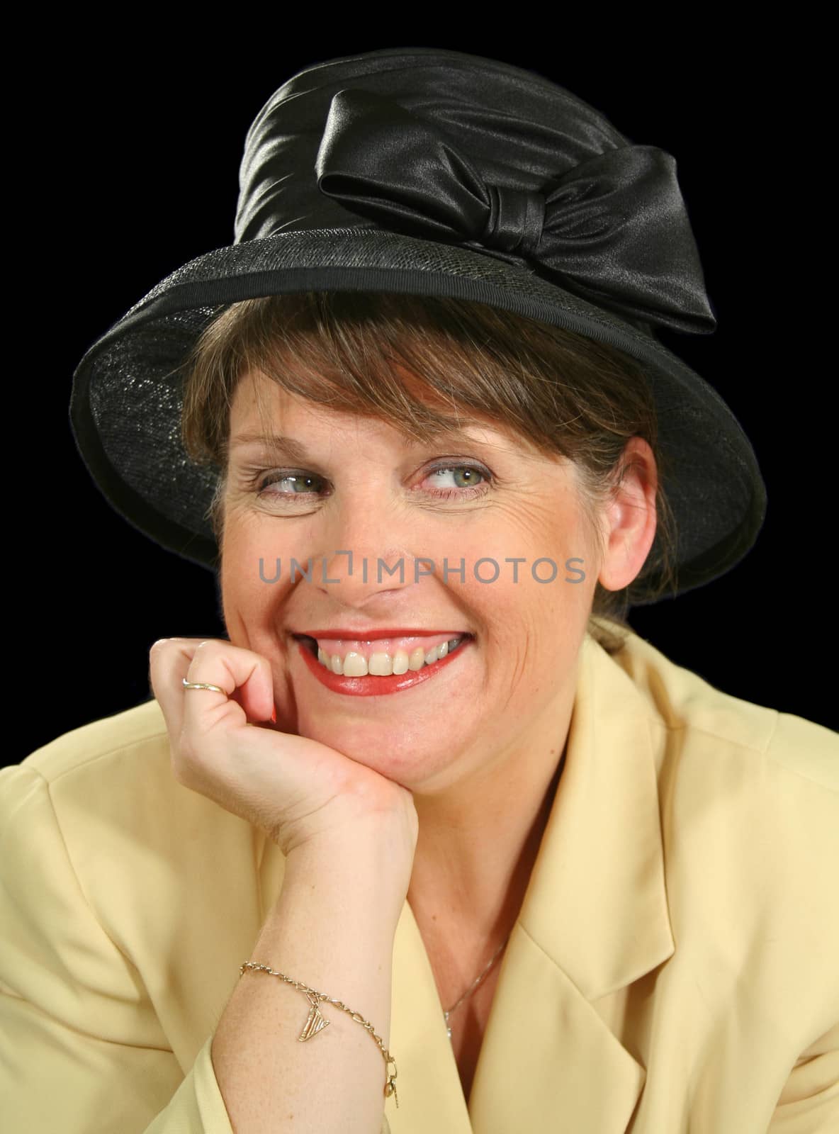 Smiling middle aged woman in a black hat.