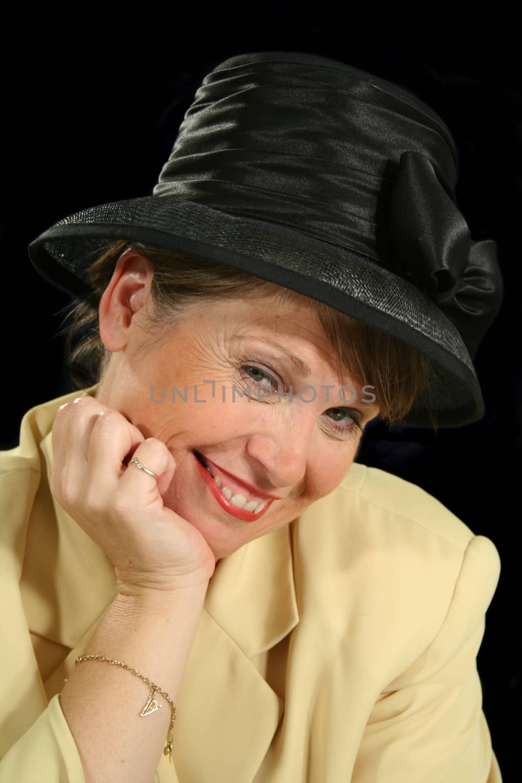 Happy and contented female in a black hat.