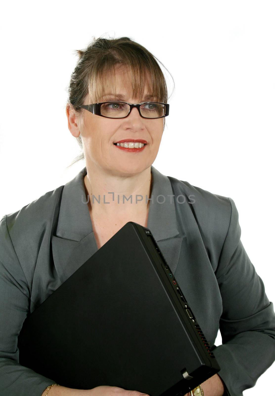 Mature businesswoman with laptop looking away and smiling.