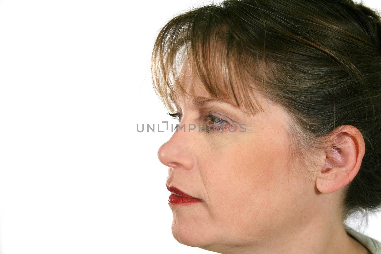 Profile of middle aged woman looking forward.