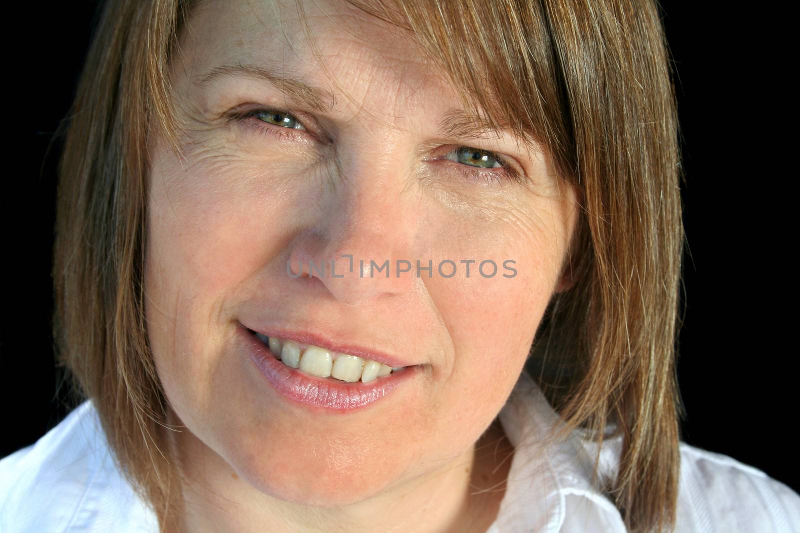 Contented middle aged woman looking at camera.