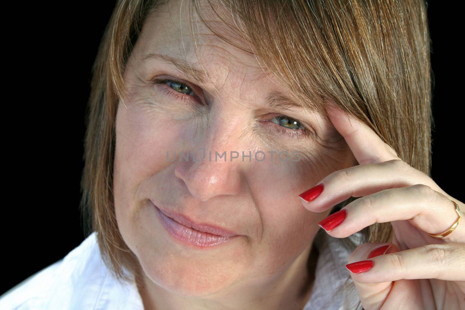 Close up of a thoughtful and pensive middle aged woman.