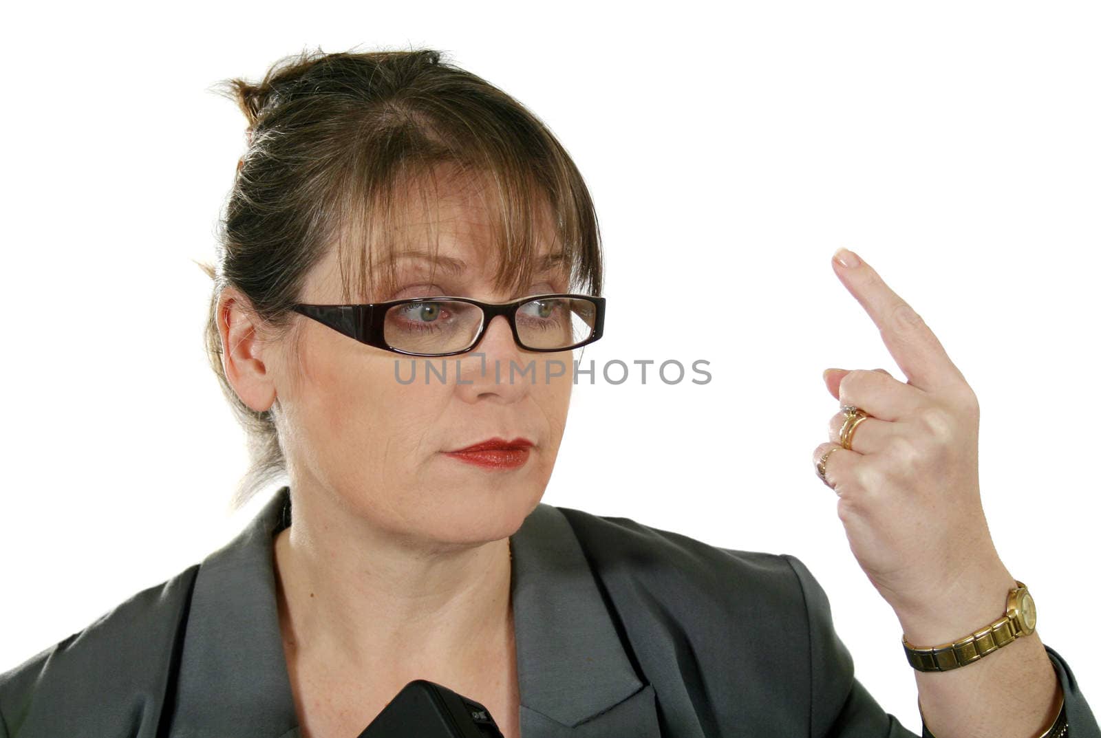 Mature businesswoman gesticulates to the assembled.