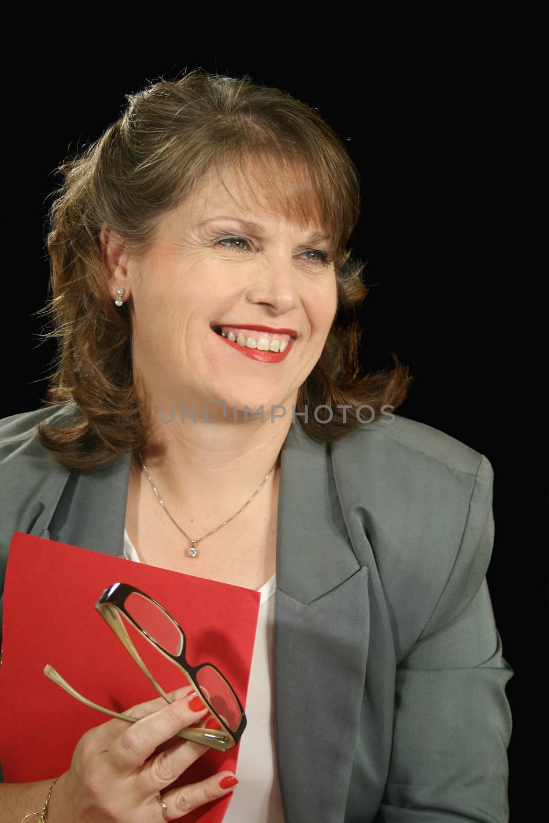 Mature businesswoman looking away and smiling.