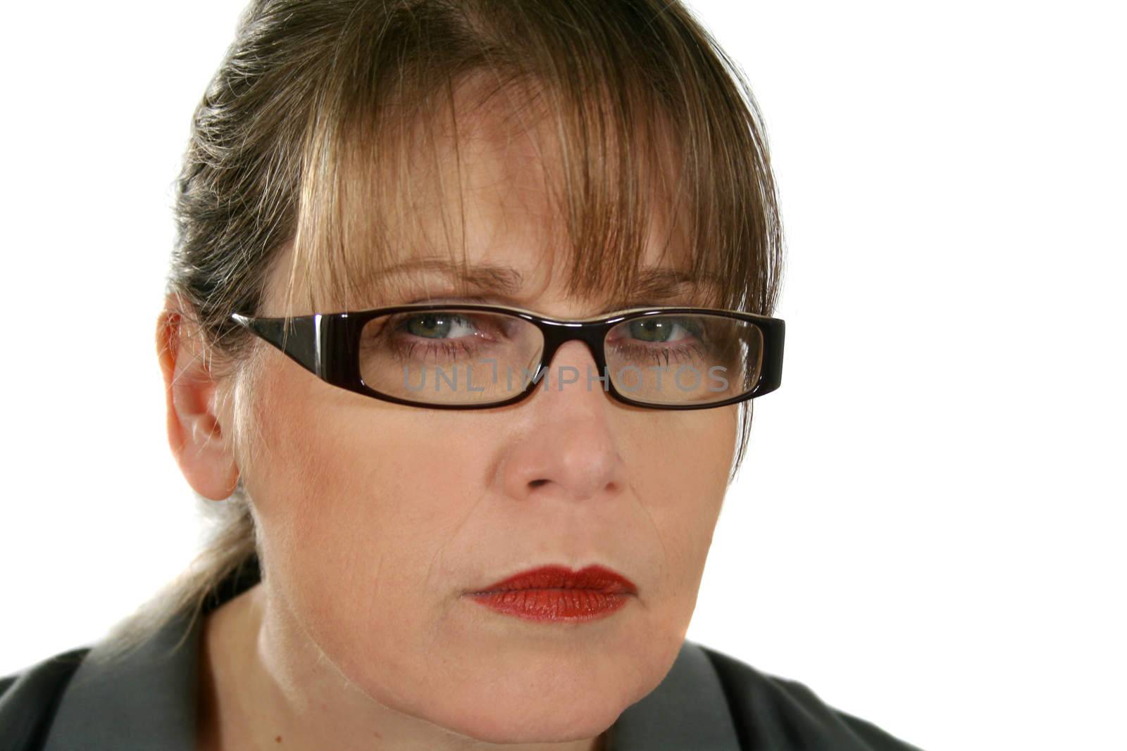 Closeup of serious and angry businesswoman with glasses staring.