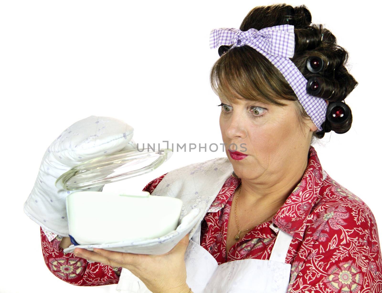 Frumpy housewife gets a surprise looking in the baking dish.