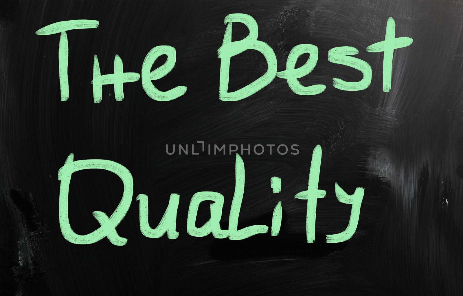 "The best quality" handwritten with white chalk on a blackboard