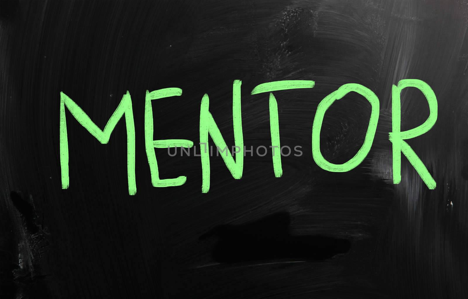 "Mentor" handwritten with white chalk on a blackboard