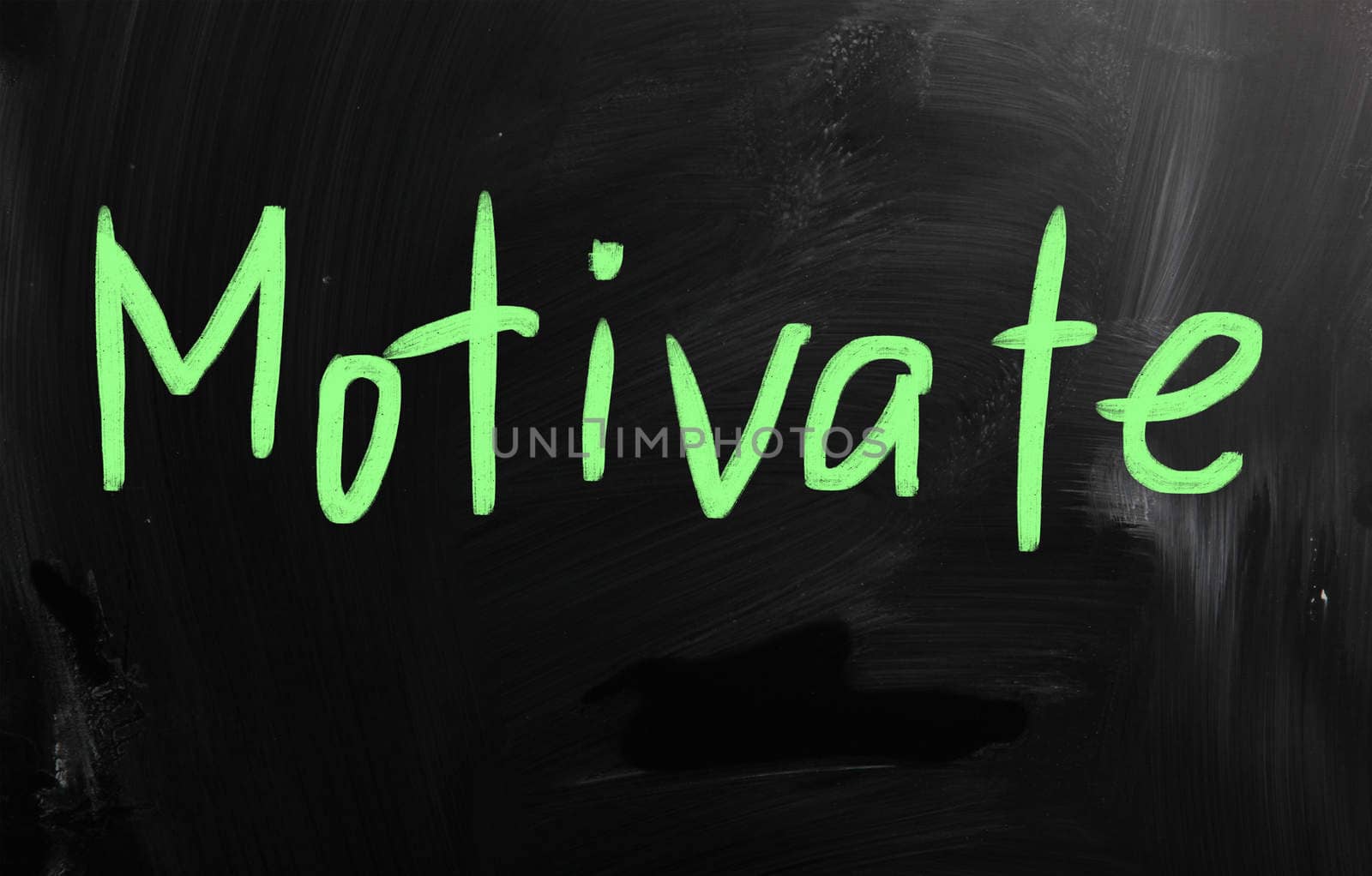 "Motivate" handwritten with white chalk on a blackboard