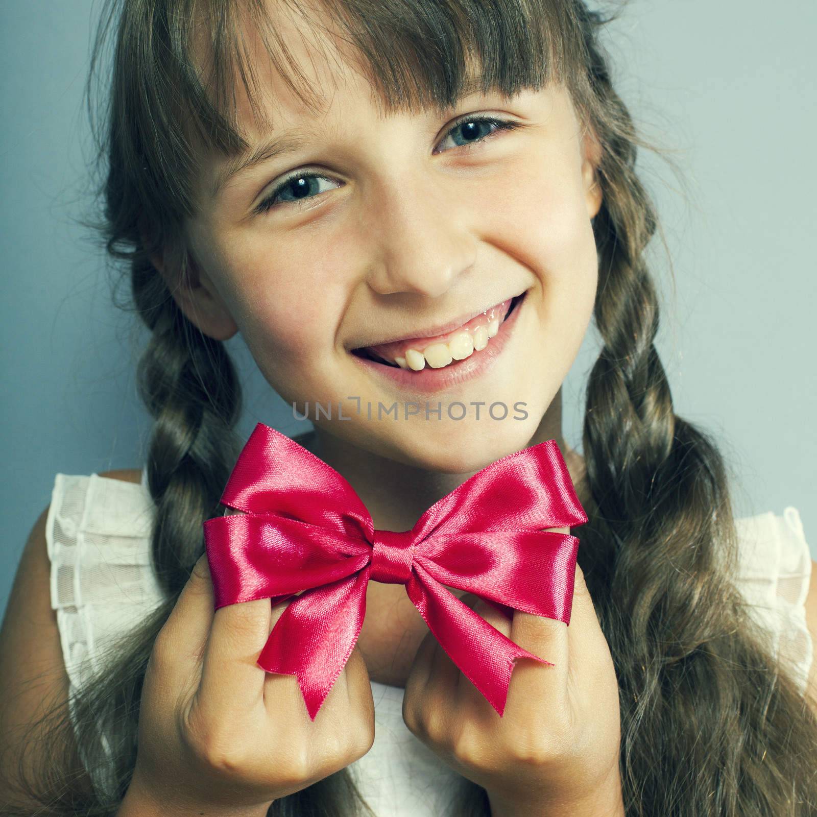 portrait of a beautiful girl with a red bow