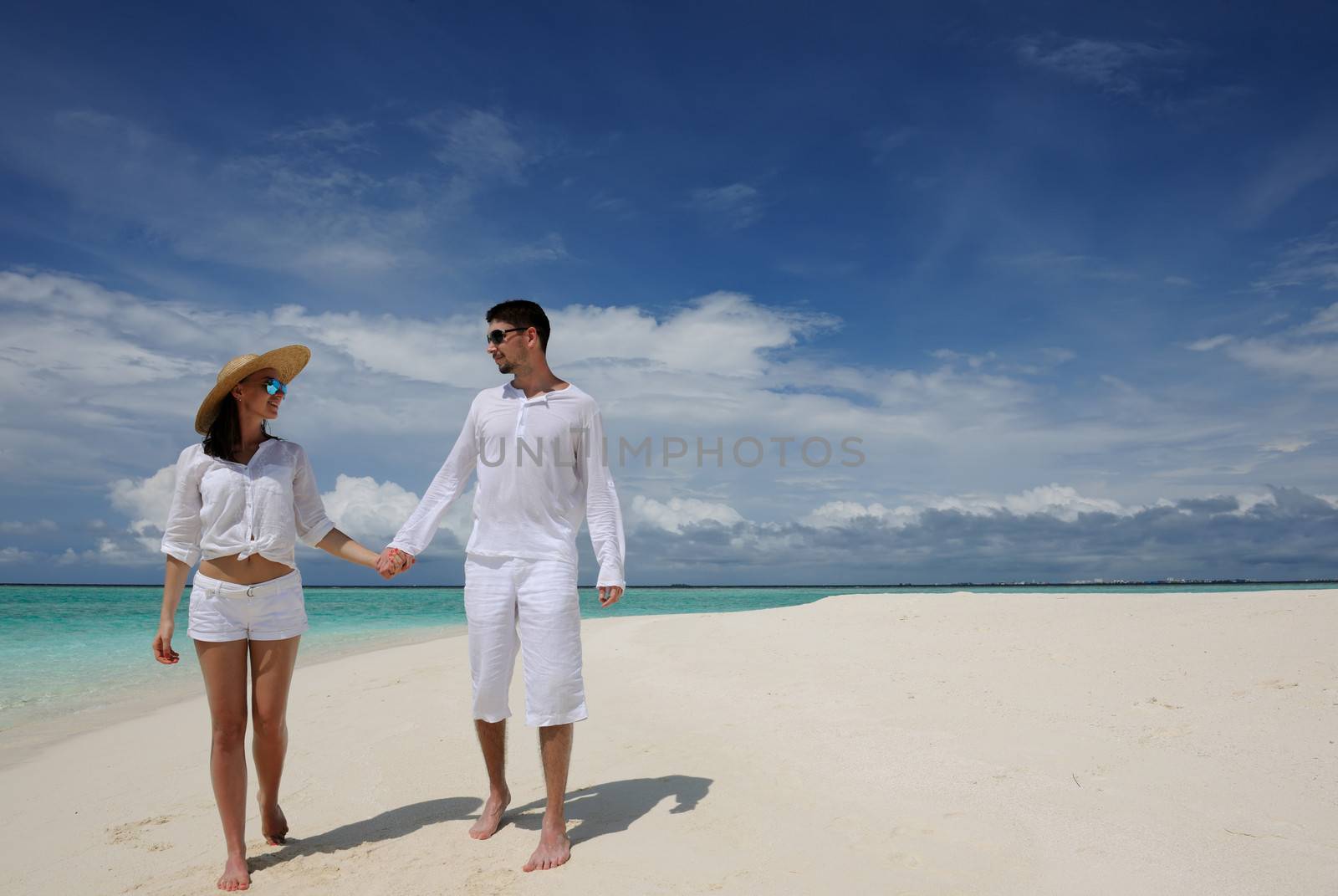 Couple on a beach at Maldives by haveseen