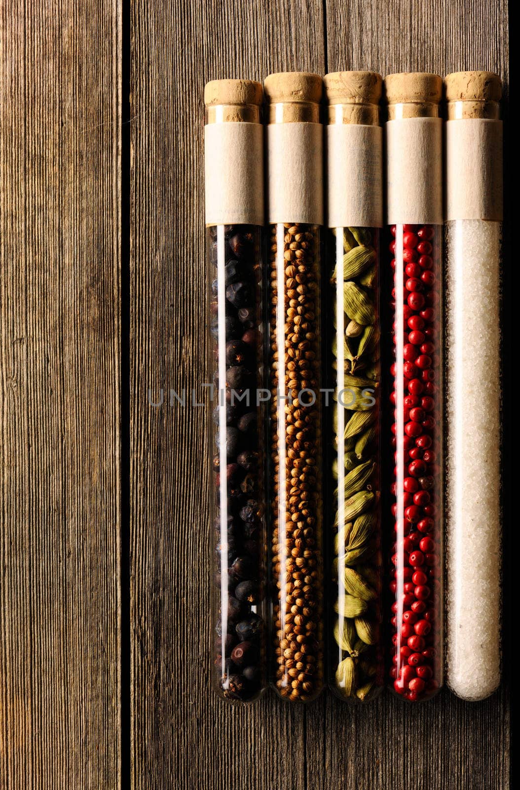 Spices in beakers on wooden table by haveseen