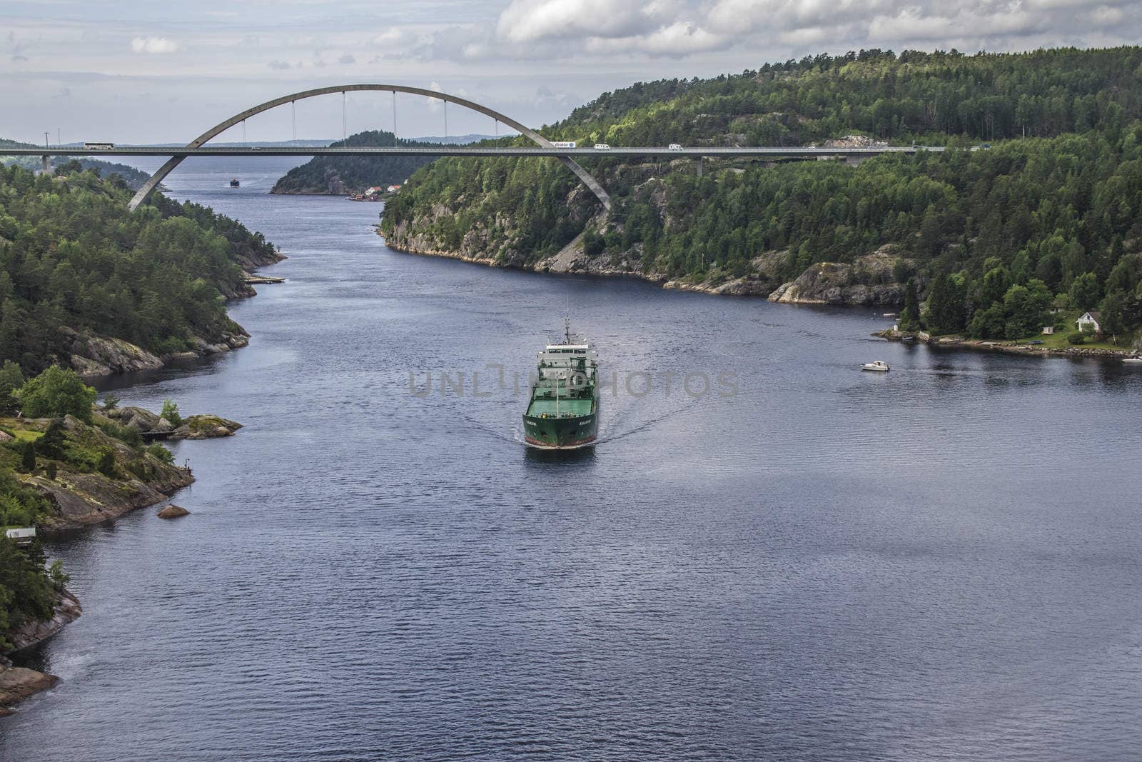 Cargo ship Kalkvik  going to the port of Halden, Norway in order to unload clay. The picture is shot from Svinesund Bridge.