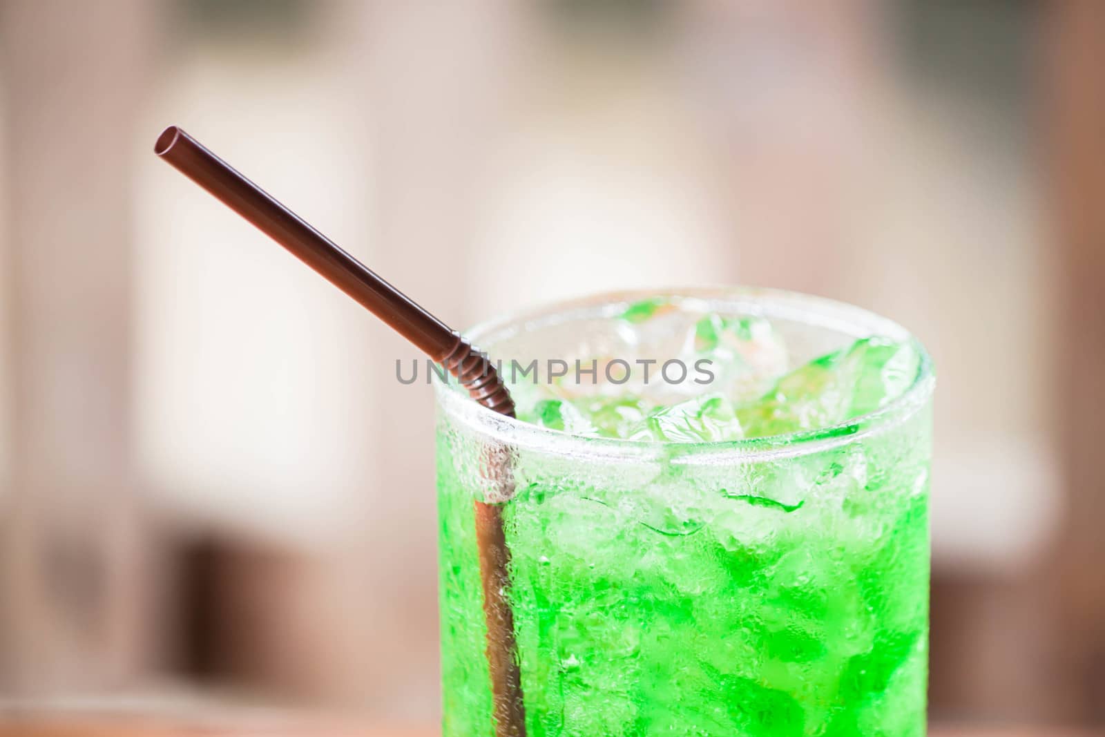 Close up ice cubes on green drink  by punsayaporn