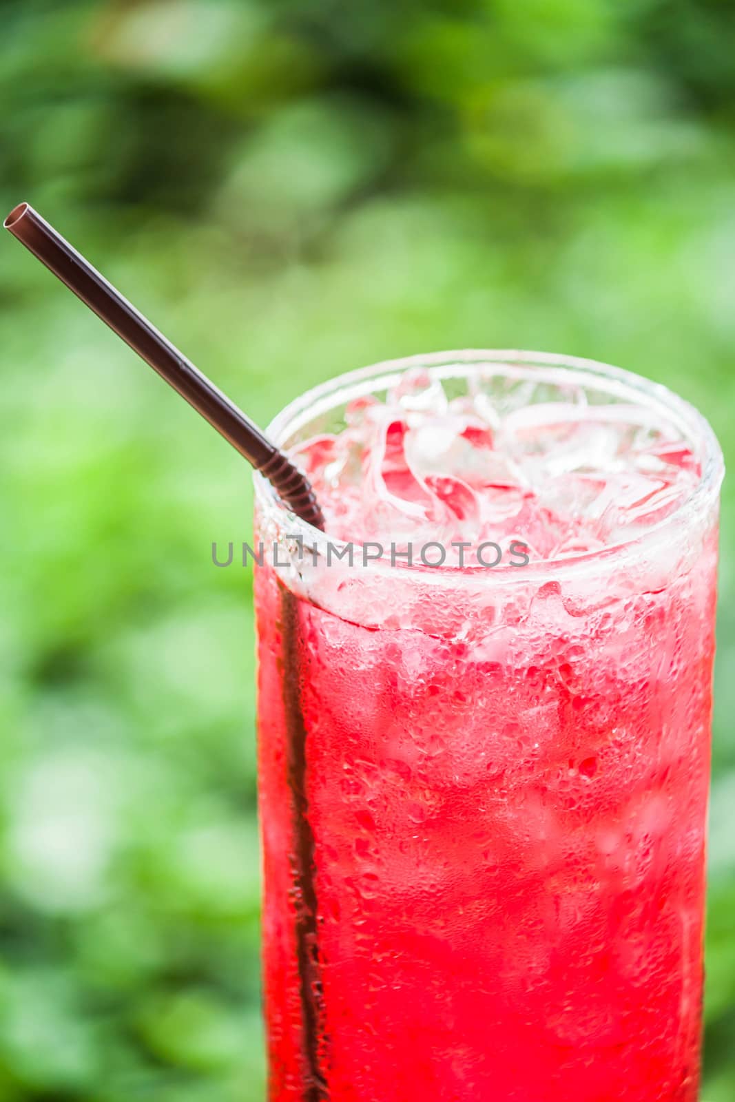 Refreshing time with glass of cold red drink