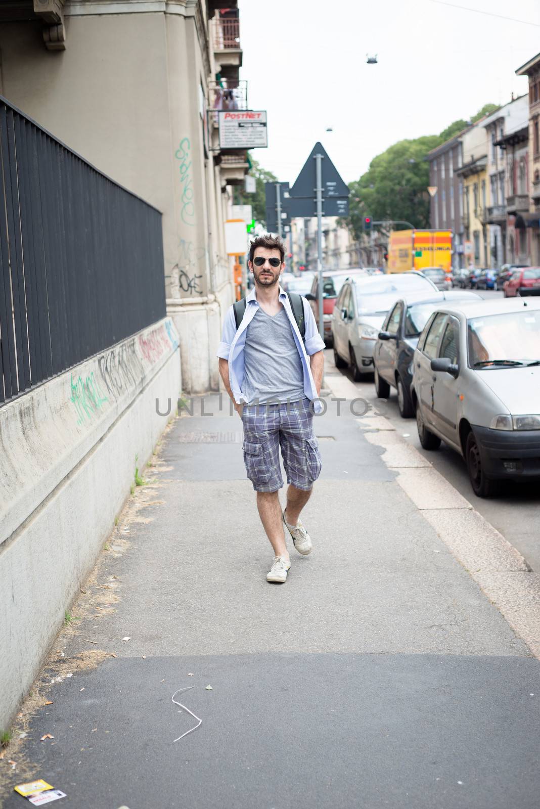 man walking in the street by peus