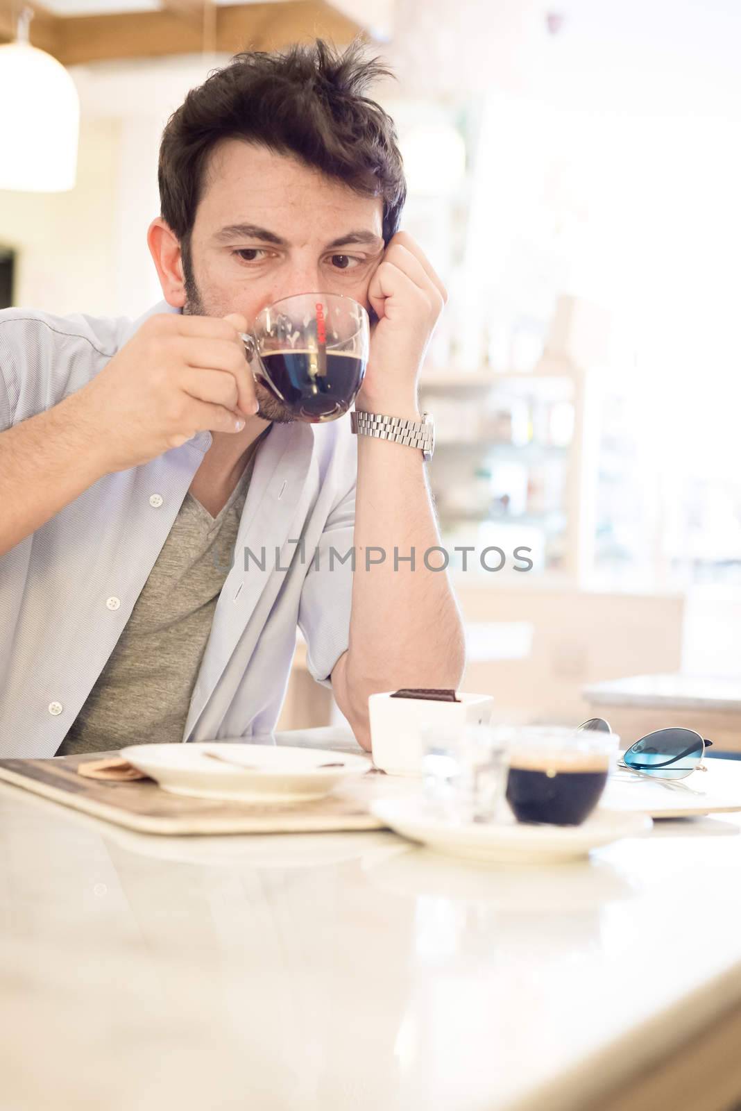 man at the bar drinking coffee in the morning