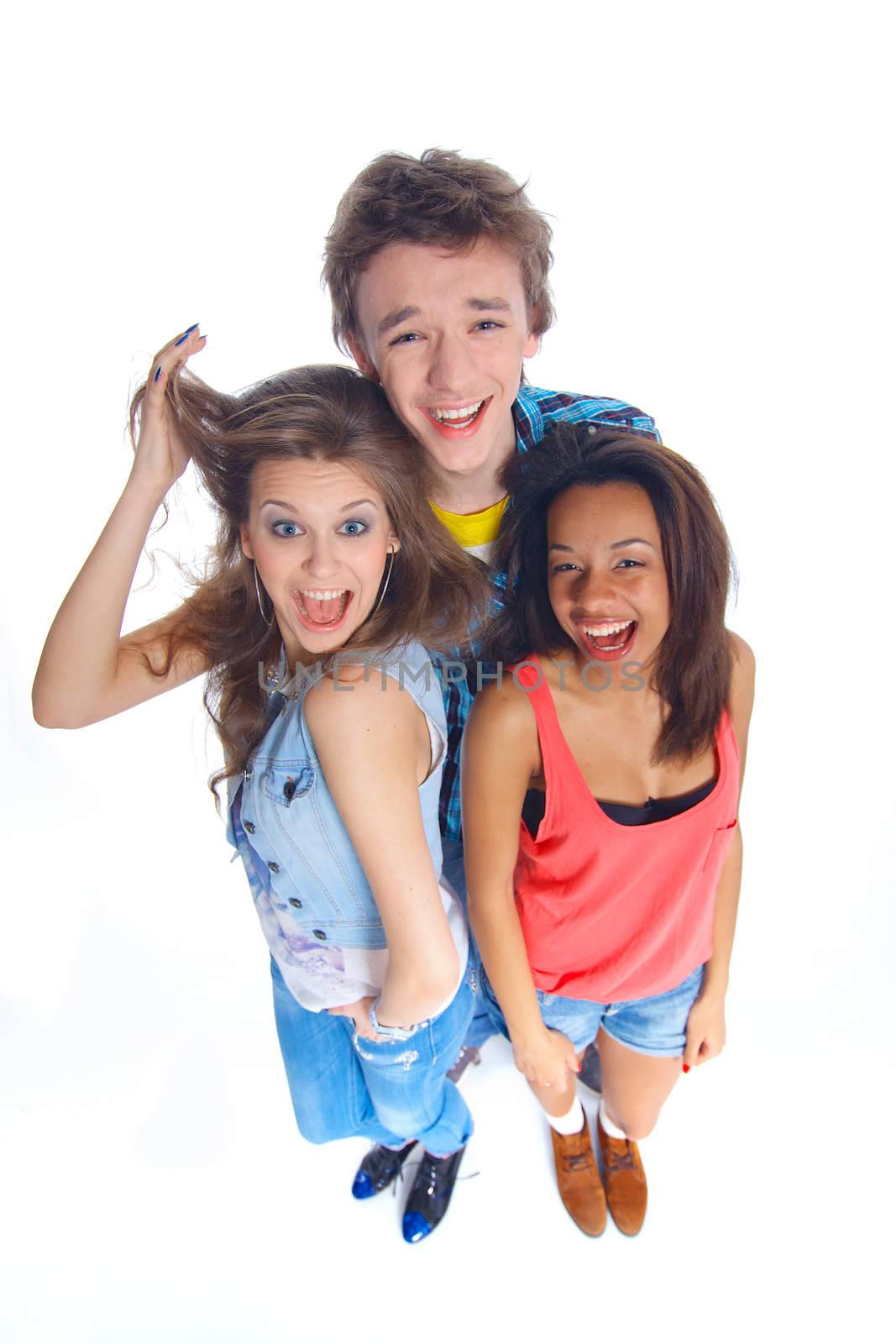 Three young happy teenagers grimacing. Isolated on white background.
