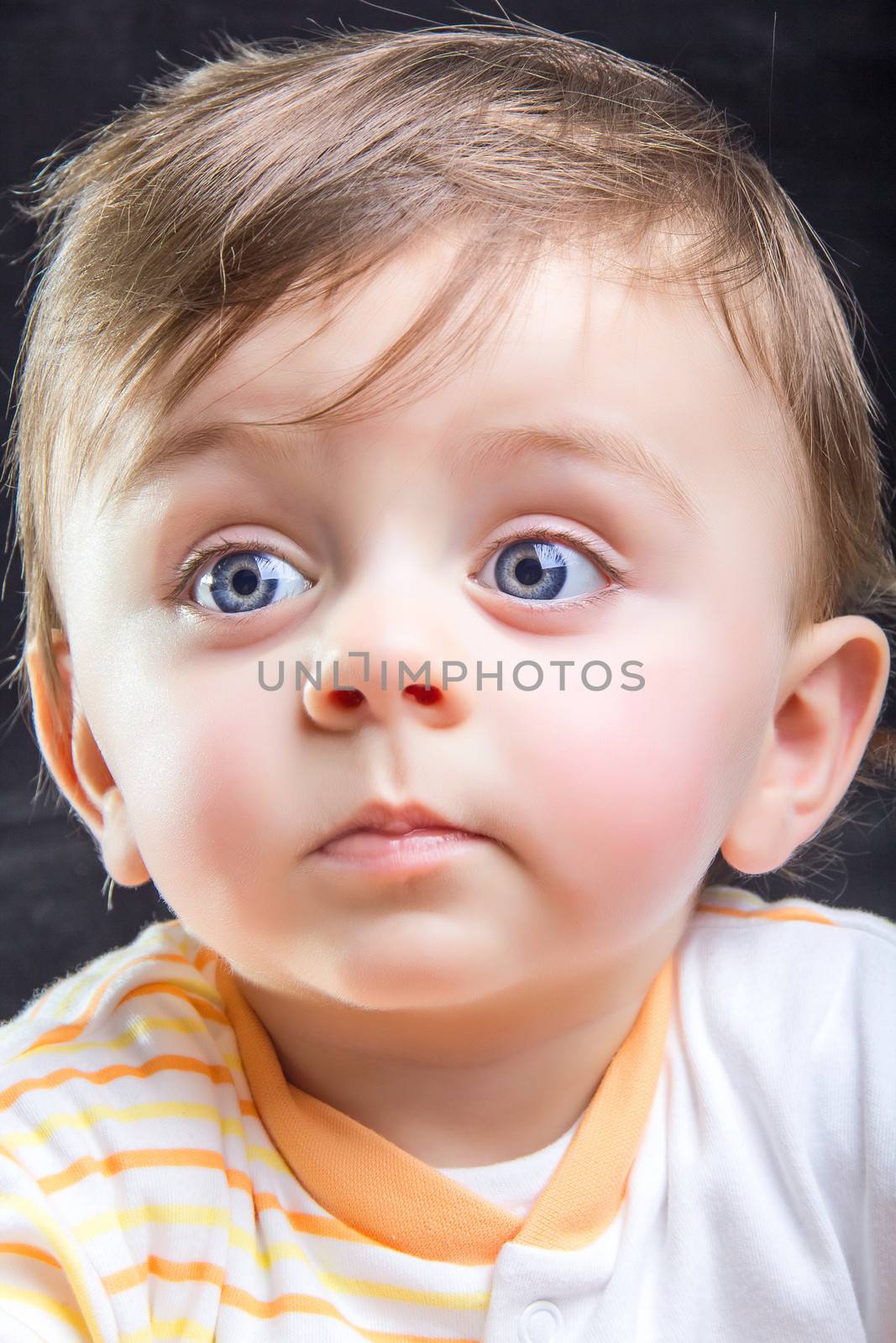 Beautiful blue eyed child looking away