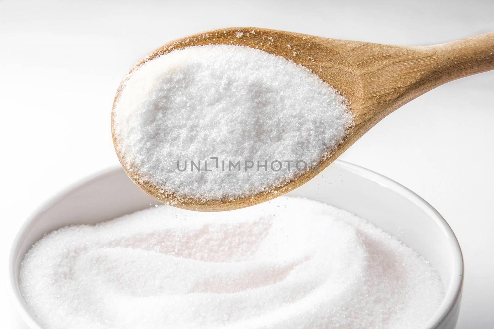 Wooden spoon and white sugar