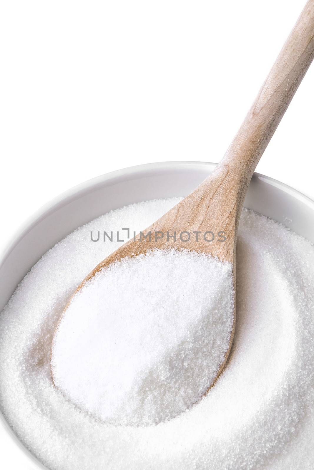 Wooden spoon and a bowl fill with sugar