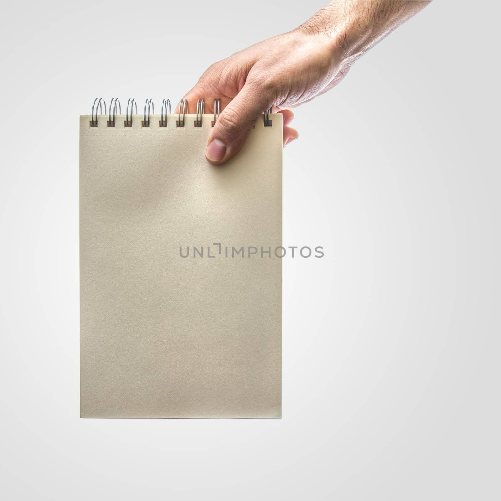 Hand holding notebook by dynamicfoto