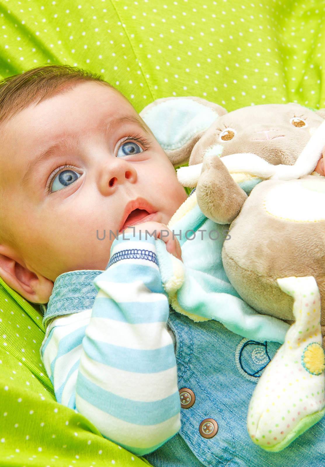 Little baby surprised by receiving his first toy