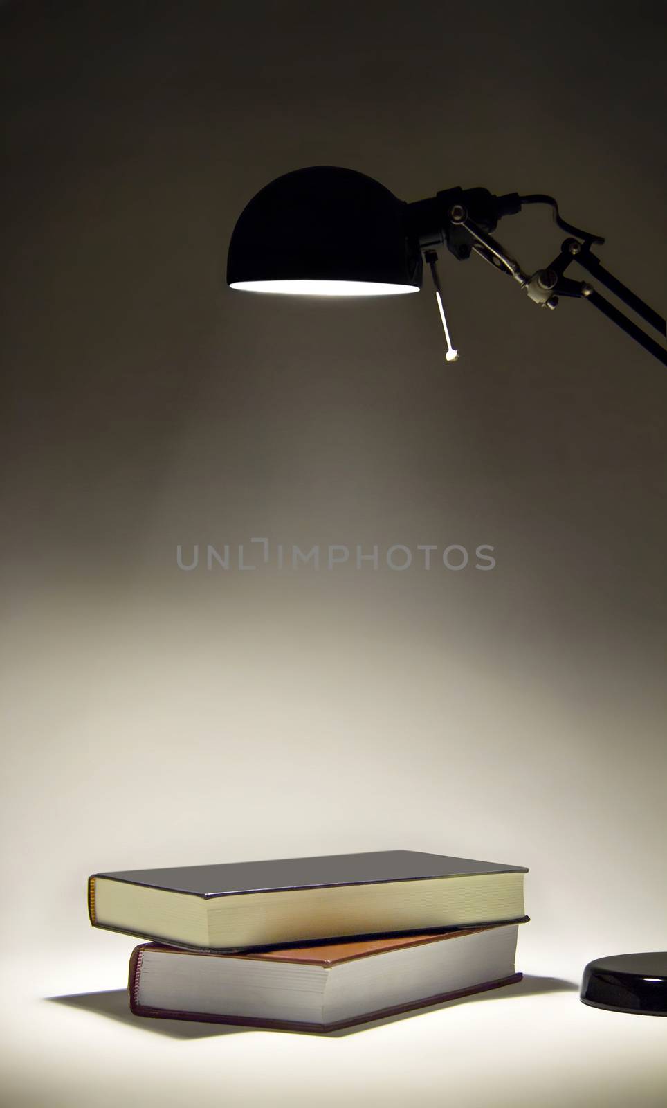 Sconce illuminating two books by dynamicfoto