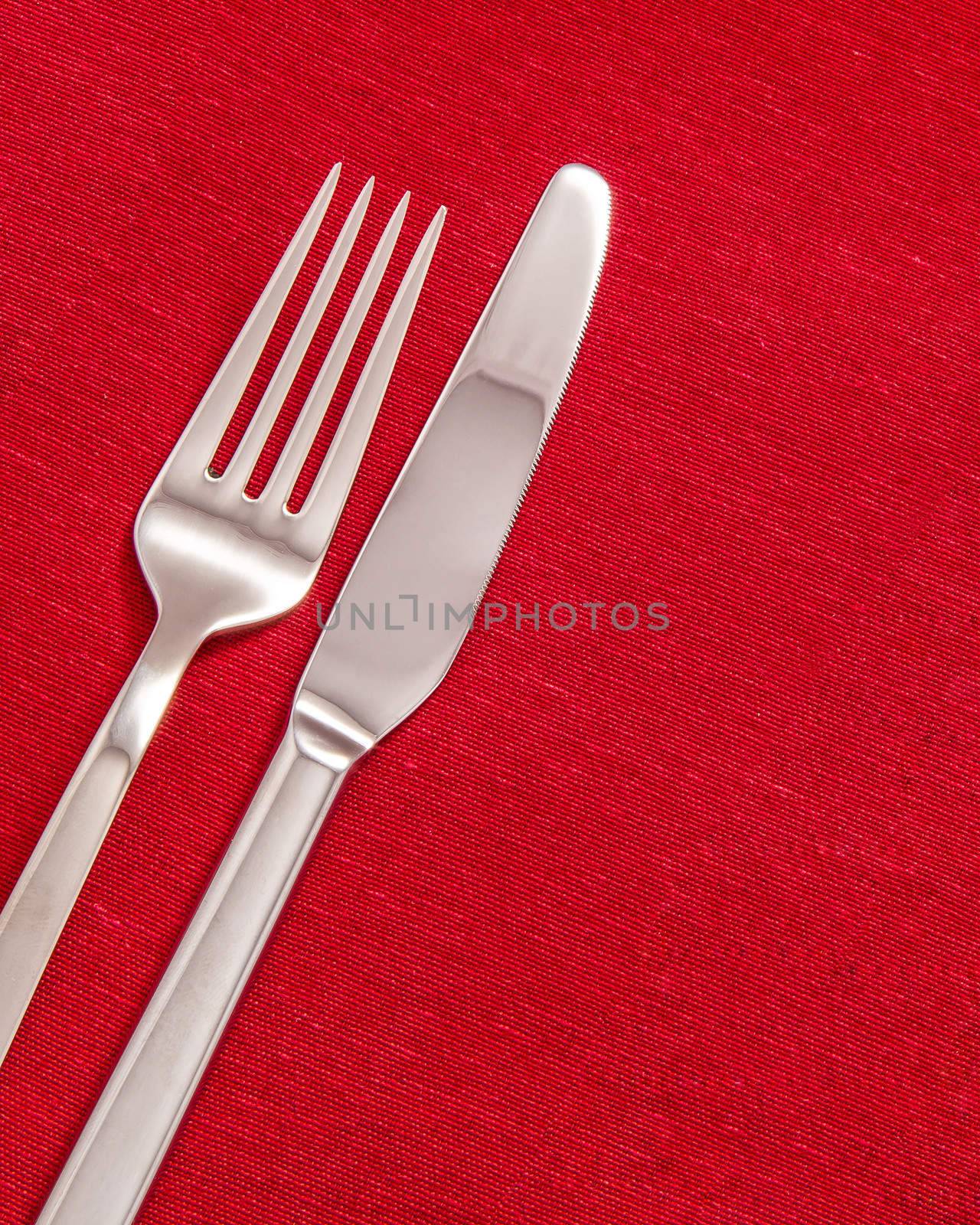 Silver Fork and knife on red table cloth