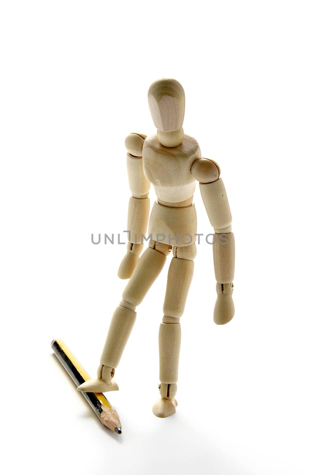 Wooden manikin and pencil on white background