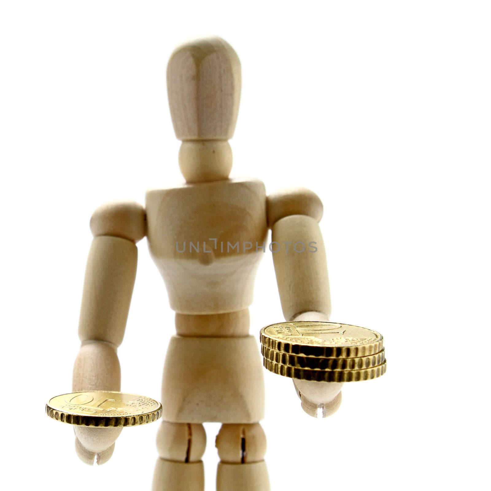 Wooden manikin holding a coin on one hand and a pile of three on the other
