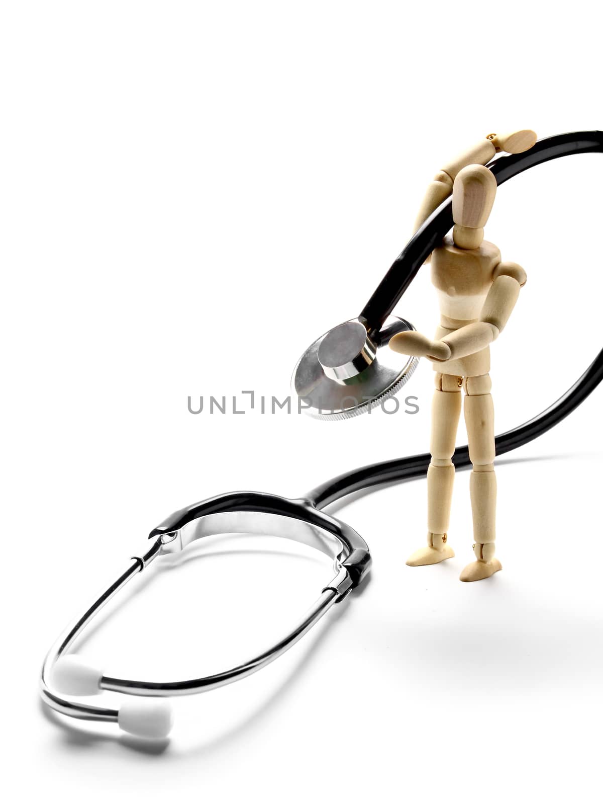 Wooden manikin carrying stethoscope on the shoulder