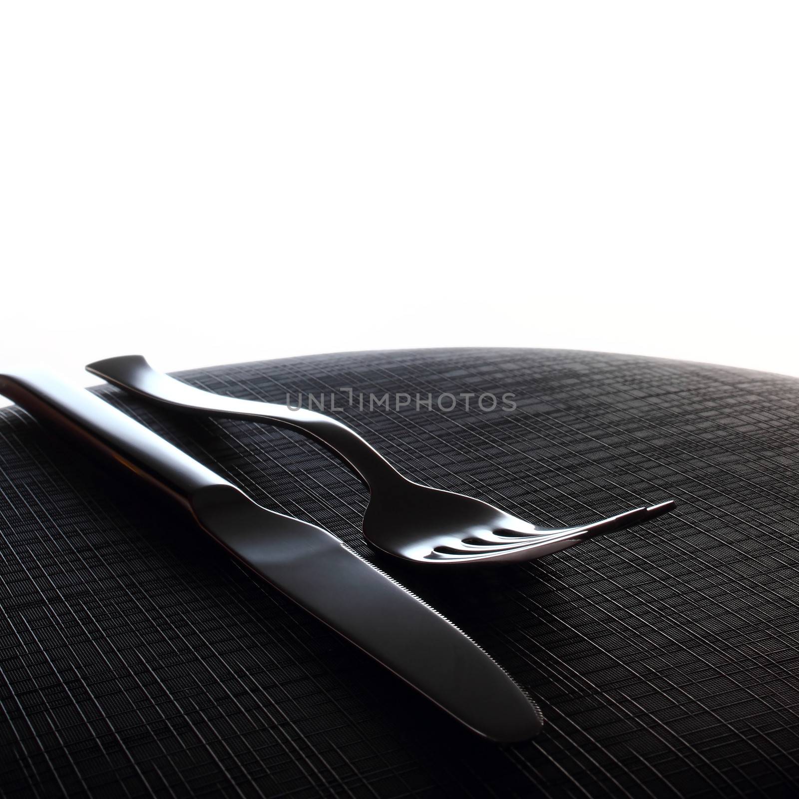 Silver Fork and knife on black surface