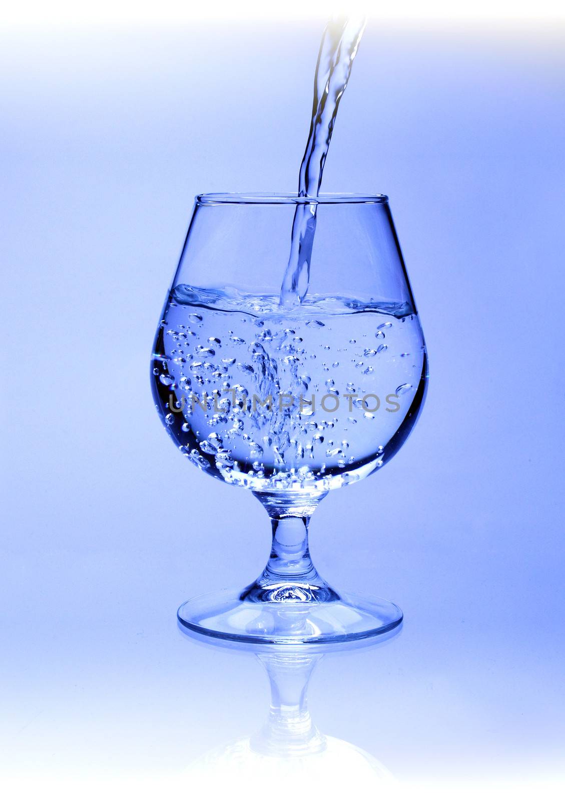 Crystal clear glass being filled with water