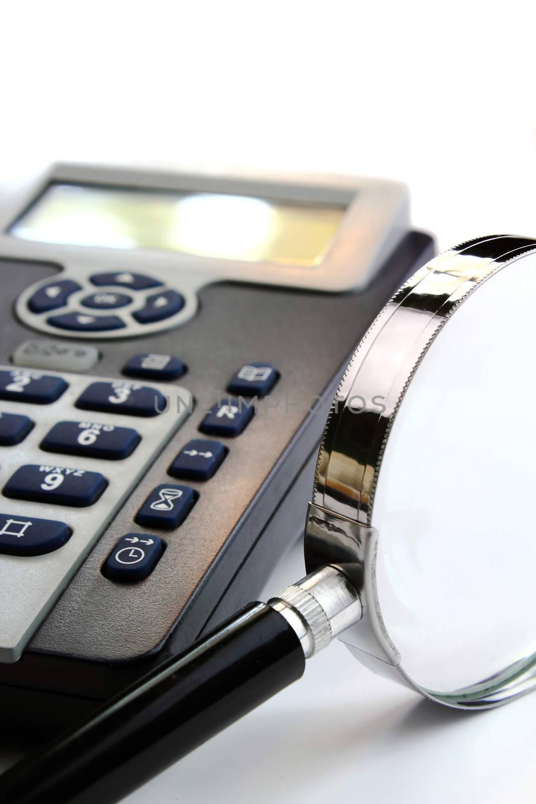 Black and silver telephone and magnification glass