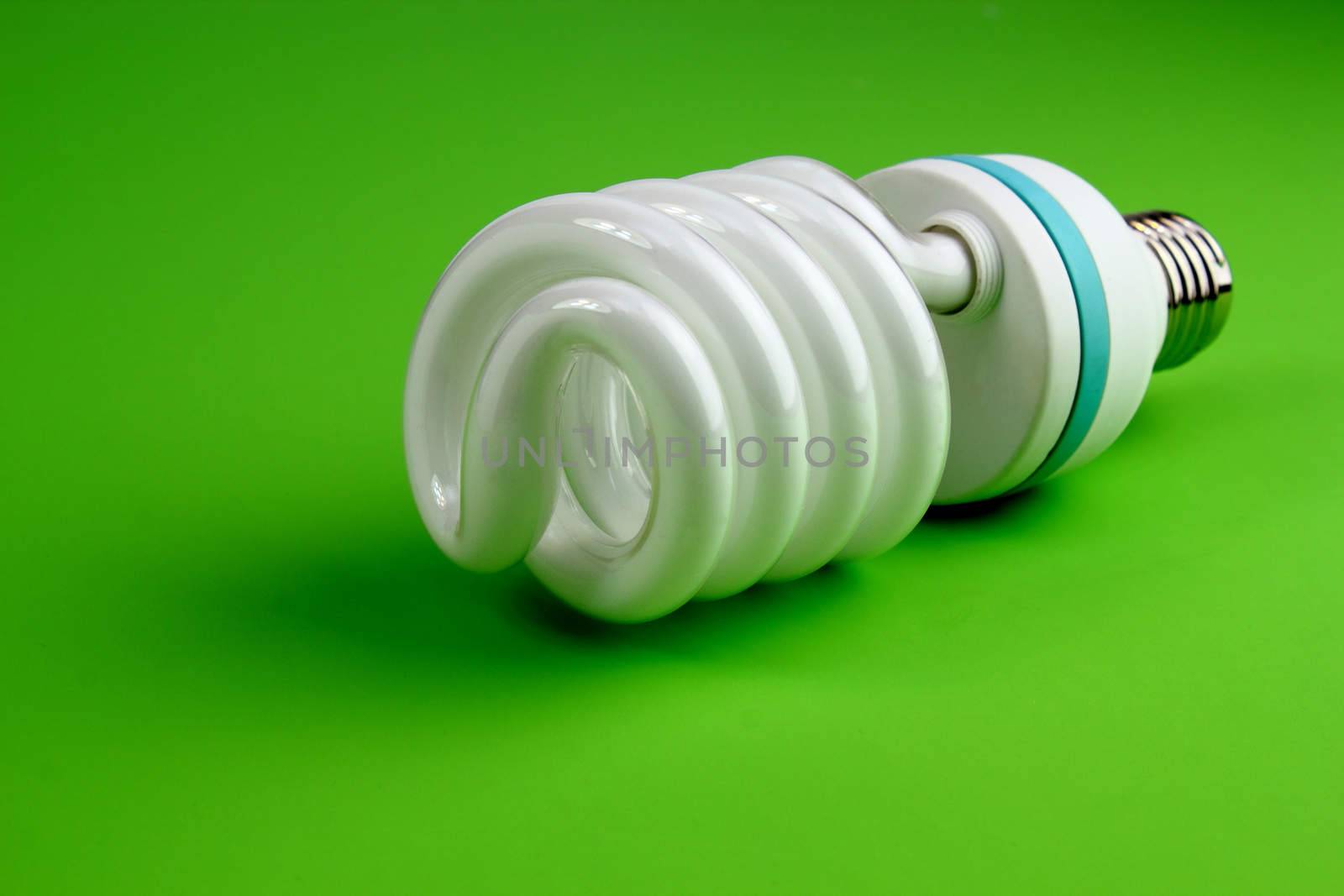 Economic light bulb on green background