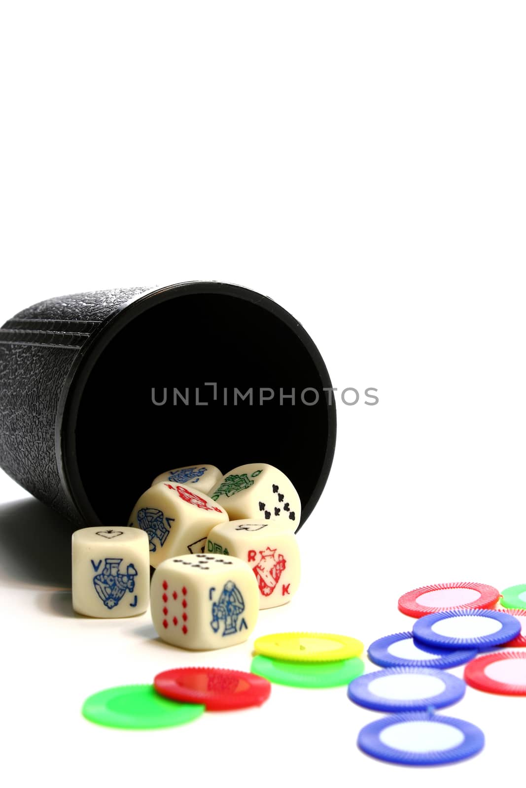 A cup throwing dice and colorful chips isolated