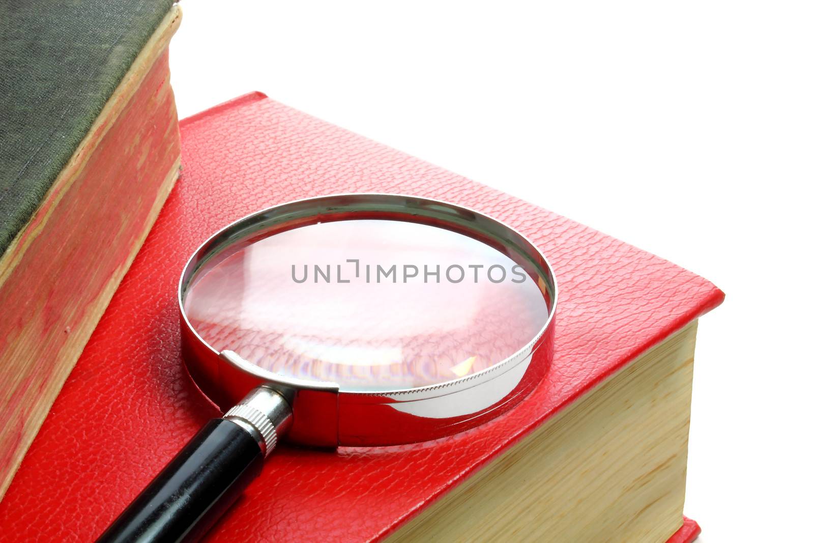 Magnification glass and books background