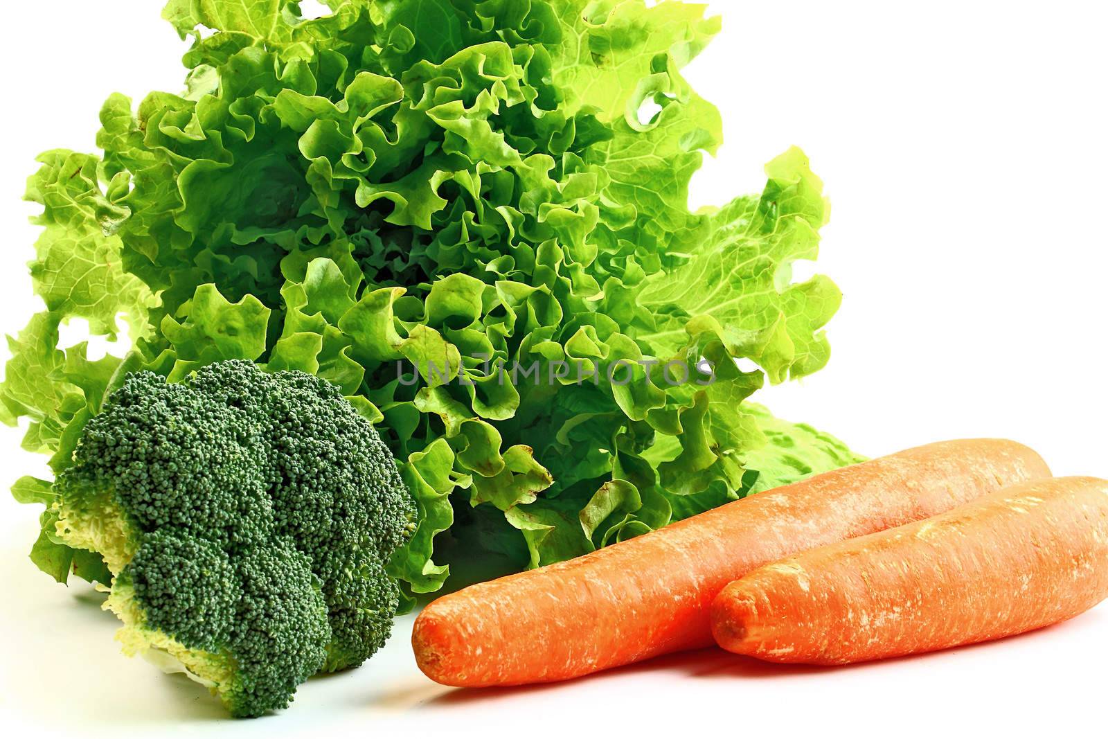 Lettuce carrots and broccoli on white